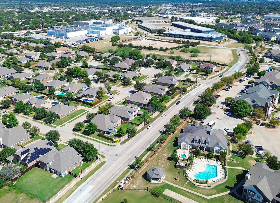 North Richland Hills, TX - Clubhouse Pool in Townhome Complex in North Richland Hills, Texas, Showing Suburban Homes on Oversized Lots, Background Mix of Commercial Buildings